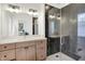 Modern bathroom features a spacious shower with marble tiling and a wooden vanity with a quartz countertop at 12874 Tradd St, Carmel, IN 46032