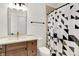 Bright bathroom features a shower/tub combination with stylish curtain, toilet, and vanity at 12874 Tradd St, Carmel, IN 46032