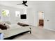 Bright primary bedroom with attached bathroom, TV, and ample natural light from large windows at 12874 Tradd St, Carmel, IN 46032