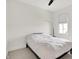 Neutral bedroom offers a minimalist aesthetic with bright white walls, and a ceiling fan at 12874 Tradd St, Carmel, IN 46032