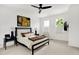 Cozy bedroom with dark wood accents, comfortable bedding, and bright, natural light at 12874 Tradd St, Carmel, IN 46032