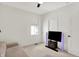 Neutral bedroom has a ceiling fan, a large window, and a set of sliding-door closet at 12874 Tradd St, Carmel, IN 46032