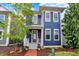 Charming two-story home featuring blue siding, white trim, a welcoming porch, and landscaped front yard at 12874 Tradd St, Carmel, IN 46032