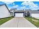Featuring a clean two-car detached garage with a white door and expansive driveway, enhancing curb appeal at 12874 Tradd St, Carmel, IN 46032
