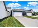 Detached two-car garage showcasing a pristine white door and a long concrete driveway for easy access at 12874 Tradd St, Carmel, IN 46032