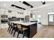 Modern kitchen featuring a large island with seating, sleek white cabinets, and stainless steel appliances at 12874 Tradd St, Carmel, IN 46032