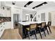 Beautiful kitchen with white cabinetry, a large center island, and open access to other living spaces at 12874 Tradd St, Carmel, IN 46032