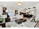 Bright, open-concept living room flows into a modern kitchen with a large island and stainless steel appliances at 12874 Tradd St, Carmel, IN 46032