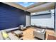 Comfortable outdoor living space featuring stylish seating and blue siding accents for relaxation and entertainment at 12874 Tradd St, Carmel, IN 46032