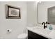 A minimalist powder room featuring a toilet, and floating vanity with quartz countertop at 12874 Tradd St, Carmel, IN 46032
