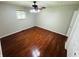 A vacant bedroom featuring hardwood floors, a ceiling fan, and a single window at 1345 S Biltmore Ave, Indianapolis, IN 46241