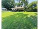 A single story home featuring a spacious front yard with green grass at 1345 S Biltmore Ave, Indianapolis, IN 46241
