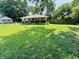 A single story home featuring a spacious front yard with green grass at 1345 S Biltmore Ave, Indianapolis, IN 46241