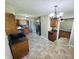 A well-lit kitchen featuring stone floors, dark wood cabinetry, and stainless steel appliances at 1345 S Biltmore Ave, Indianapolis, IN 46241