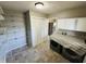 Laundry room with washer, dryer, and shelving unit at 1345 S Biltmore Ave, Indianapolis, IN 46241