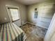 Mud room with shelving, door to outside, and neutral flooring at 1345 S Biltmore Ave, Indianapolis, IN 46241