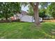 Expansive back yard featuring lush green grass, a classic tree, and new wooden fences at 1648 Ringgold Ave, Indianapolis, IN 46203