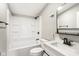 Bathroom with white tub, toilet, vanity, and black hardware at 1648 Ringgold Ave, Indianapolis, IN 46203