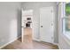 Bedroom view into kitchen, featuring light grey walls and light-toned wood flooring at 1648 Ringgold Ave, Indianapolis, IN 46203