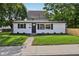 Charming home featuring a well-manicured front lawn and a freshly painted exterior at 1648 Ringgold Ave, Indianapolis, IN 46203