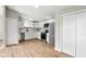 Bright kitchen featuring stainless appliances, white cabinetry, and light-toned wood flooring at 1648 Ringgold Ave, Indianapolis, IN 46203