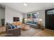 Bright living room featuring stylish furnishings, a large window, and hardwood floors at 1648 Ringgold Ave, Indianapolis, IN 46203