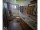 Bathroom in disrepair with stained floors, outdated fixtures, and peeling paint showing need for renovation at 1816 E Highland Ave, Muncie, IN 47303