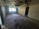 Living room features a ceiling fan and a large window at 1816 E Highland Ave, Muncie, IN 47303