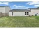 Well-maintained backyard with green grass, white siding and door leading inside at 1912 Blue Pine Ln, Indianapolis, IN 46231