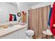 Functional bathroom with a neutral color scheme, featuring a sink, toilet, and shower with curtain at 1912 Blue Pine Ln, Indianapolis, IN 46231