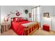 Cozy bedroom featuring a comfortable bed with red accents and warm lighting, creating an inviting space at 1912 Blue Pine Ln, Indianapolis, IN 46231