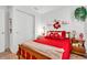 Cozy bedroom featuring a comfortable bed with red accents and warm lighting, creating an inviting space at 1912 Blue Pine Ln, Indianapolis, IN 46231