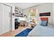 Bright bedroom with a comfortable bed, a built-in bookshelf, and a window providing natural light at 1912 Blue Pine Ln, Indianapolis, IN 46231