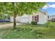 Well-kept suburban home with a green lawn and mature tree in the front yard at 1912 Blue Pine Ln, Indianapolis, IN 46231