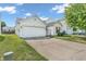 Suburban house with a driveway and attached garage at 1912 Blue Pine Ln, Indianapolis, IN 46231