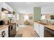 Efficient kitchen layout with modern appliances, white cabinetry and a seamless connection to the adjacent dining area at 1912 Blue Pine Ln, Indianapolis, IN 46231