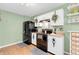 Compact kitchen with white cabinets, black appliances and modern conveniences, ideal for efficient meal preparation at 1912 Blue Pine Ln, Indianapolis, IN 46231