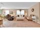 Comfortable living room with neutral colors, a cozy seating area, and large windows for natural light at 1912 Blue Pine Ln, Indianapolis, IN 46231