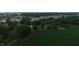An aerial view showcasing a serene property with farmland, buildings, and greenery at 2000 Hawthorne Dr, Plainfield, IN 46168