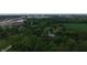Aerial view showing the home surrounded by large field and trees in residential area at 2000 Hawthorne Dr, Plainfield, IN 46168