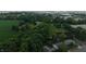 An aerial view of the property showing the house, a large field and more buildings nearby at 2000 Hawthorne Dr, Plainfield, IN 46168