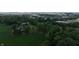 Expansive aerial view showcases the house with a field in a leafy, green neighborhood at 2000 Hawthorne Dr, Plainfield, IN 46168