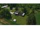 An aerial perspective showcasing the home, outbuilding, and surrounding greenery at 2000 Hawthorne Dr, Plainfield, IN 46168