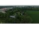 Overhead view shows the house, buildings, and farm with commercial development in the background at 2000 Hawthorne Dr, Plainfield, IN 46168