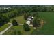 An aerial view featuring a home with cornfield, garden, and mature trees at 2000 Hawthorne Dr, Plainfield, IN 46168