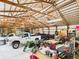 Bright and spacious barn interior with multiple vehicles, equipment, and organized storage areas at 2000 Hawthorne Dr, Plainfield, IN 46168