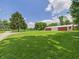 View of lush green lawn with barn in the background under a bright blue sky at 2000 Hawthorne Dr, Plainfield, IN 46168