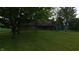 Front exterior view of the home with stone, lawn, and mature trees at 2000 Hawthorne Dr, Plainfield, IN 46168