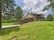 Multi-level home with stone facade, multiple decks, and well-maintained landscaping on a grassy hill at 2000 Hawthorne Dr, Plainfield, IN 46168