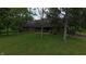 Exterior view of home with stone, well maintained lawn, and mature trees at 2000 Hawthorne Dr, Plainfield, IN 46168